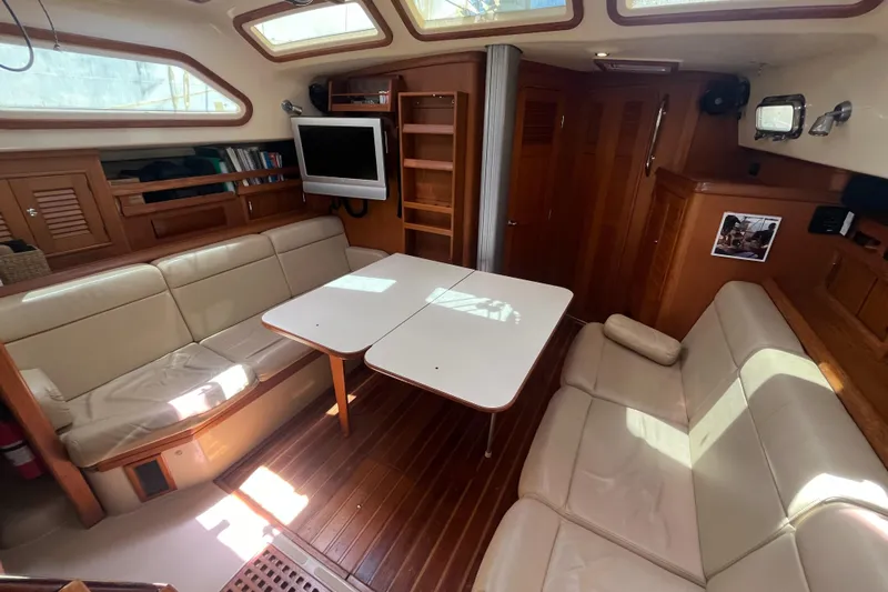 Ruby Lee Yacht Photos Pics Interior of 2006 Island Packet 445 yacht with beige seating and wooden accents.