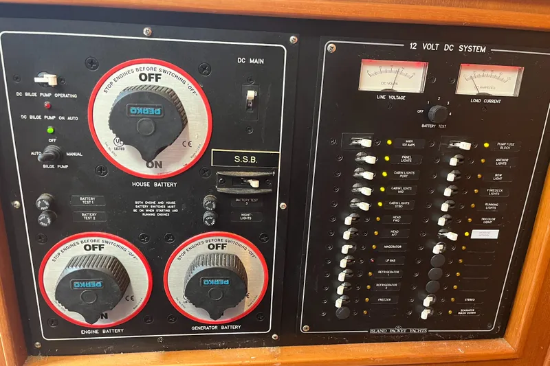 Ruby Lee Yacht Photos Pics Electrical control panel of a 2006 Island Packet 445 yacht, featuring battery switches and circuit breakers.