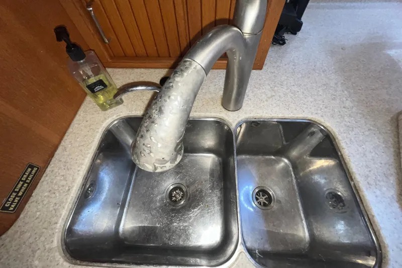 Ruby Lee Yacht Photos Pics Double stainless steel sink with faucet in 2006 Island Packet 445 yacht kitchen.