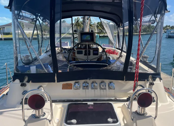 Ruby Lee Yacht Photos Pics 2006 Island Packet 445 sailboat cockpit with navigation equipment and protective canopy.