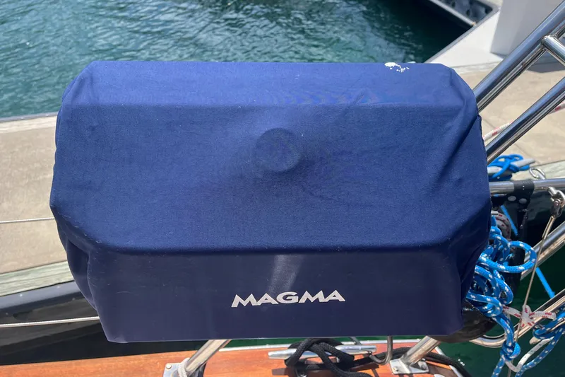 Ruby Lee Yacht Photos Pics Blue Magma grill cover on Island Packet 445 sailboat, docked by the water.