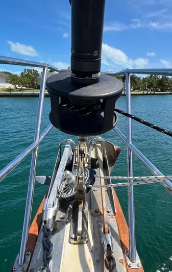 Ruby Lee Yacht Photos Pics Bow of 2006 Island Packet 445 sailboat with anchor and rigging, on calm water.