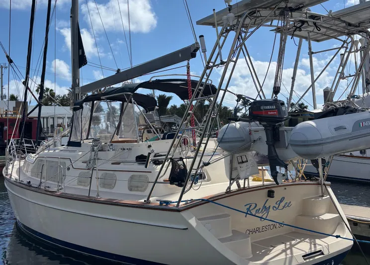 Ruby Lee Yacht Photos Pics 2006 Island Packet 445 sailboat docked, featuring a spacious deck and mounted dinghy.
