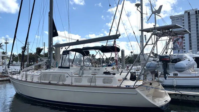 Ruby Lee Yacht Photos Pics 2006 Island Packet 445 sailboat docked in a marina, clear sky background.