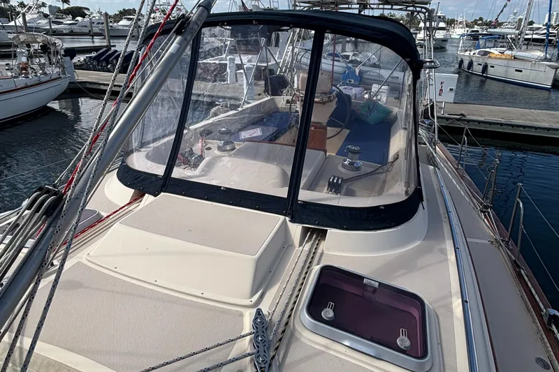 Ruby Lee Yacht Photos Pics 2006 Island Packet 445 sailboat docked at marina, featuring spacious deck and cockpit enclosure.