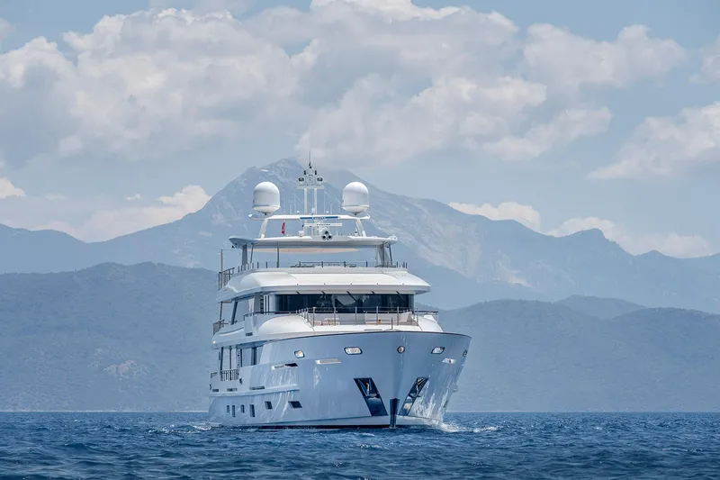 Sunrise Yacht Photos Pics Luxurious 2019 Yildiz 141 yacht cruising with scenic mountain backdrop.