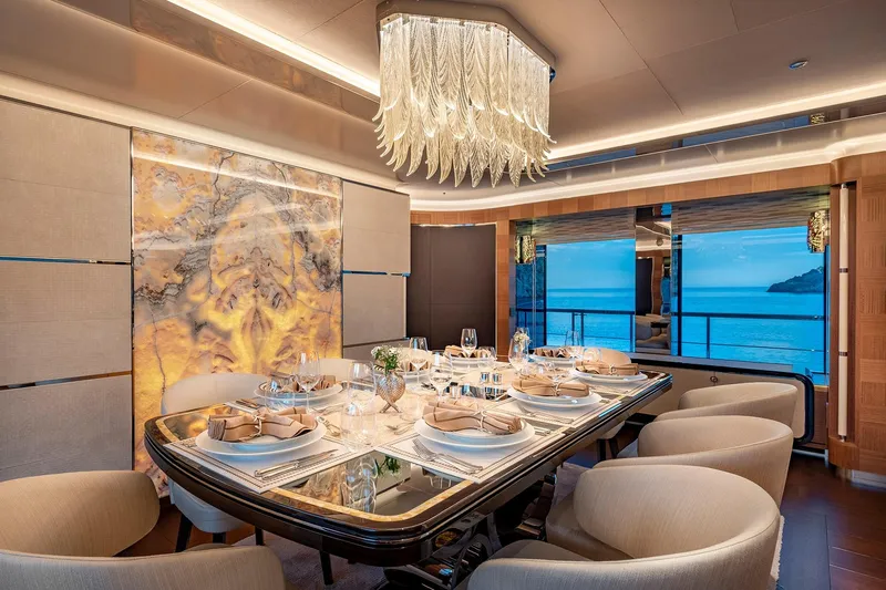 Sunrise Yacht Photos Pics Luxurious dining area on 2019 Yildiz 141 yacht with elegant chandelier and ocean view.