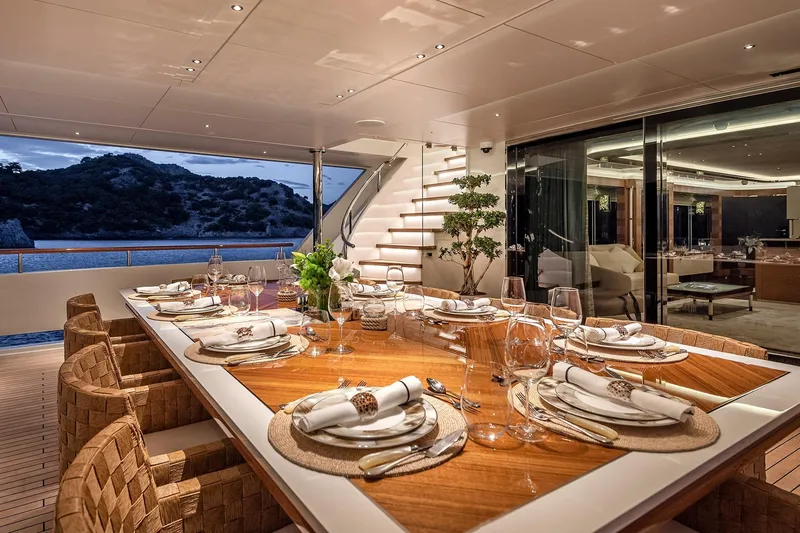 Sunrise Yacht Photos Pics Luxurious dining area on 2019 Yildiz 141 yacht, elegantly set table with ocean view.