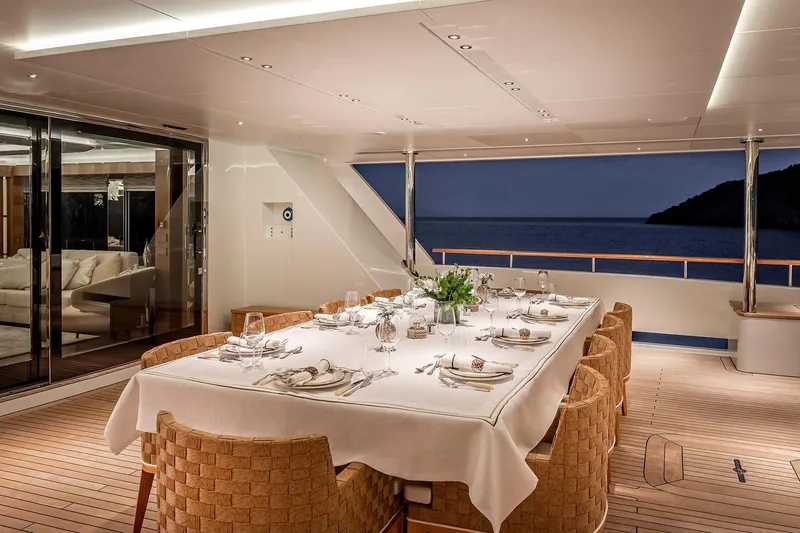 Sunrise Yacht Photos Pics Luxurious dining area on 2019 Yildiz 141 yacht, elegantly set table with ocean view.