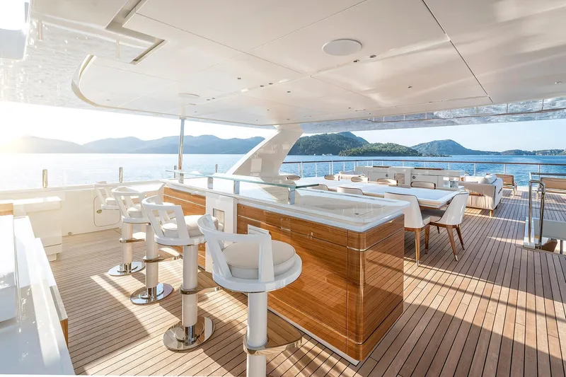Sunrise Yacht Photos Pics Luxurious Yildiz 141 yacht deck with bar and seating, overlooking serene ocean view, 2019 model.