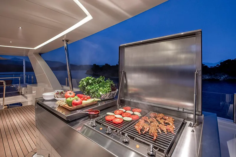 Sunrise Yacht Photos Pics Luxury yacht Yildiz 141, 2019 model, featuring an elegant outdoor grill setup at sunset.