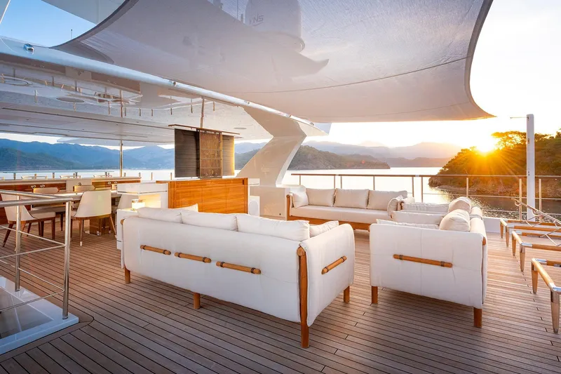 Sunrise Yacht Photos Pics Luxurious Yildiz 141 yacht deck with elegant seating, overlooking serene sunset views, 2019 model.
