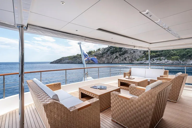 Sunrise Yacht Photos Pics Luxurious Yildiz 141 yacht deck with elegant seating, overlooking serene ocean and rocky coastline, 2019 model.