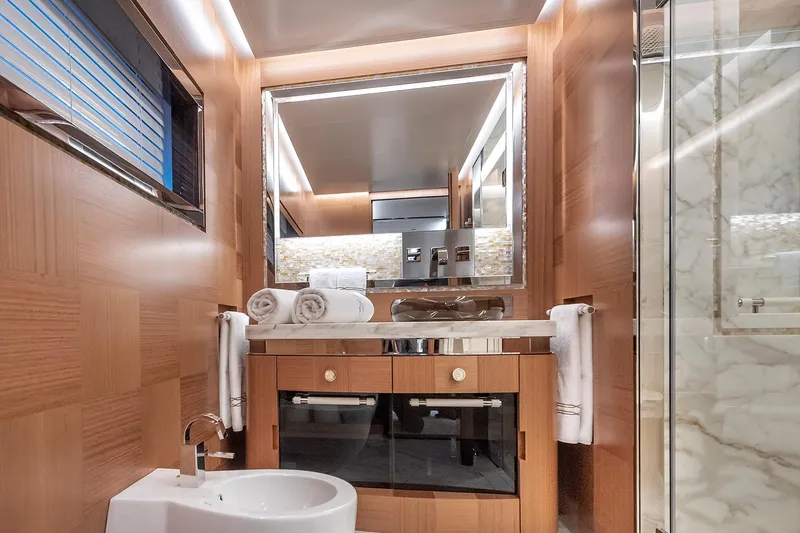 Sunrise Yacht Photos Pics Luxurious yacht bathroom with wood accents, marble shower, and elegant vanity. Yildiz 141, 2019 model.