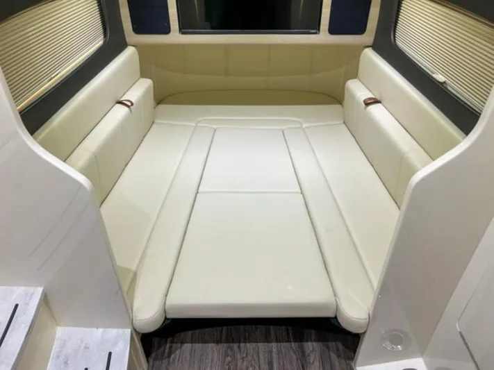  Yacht Photos Pics 2023 Scout 400 LXF cabin interior with beige seating and wood flooring.