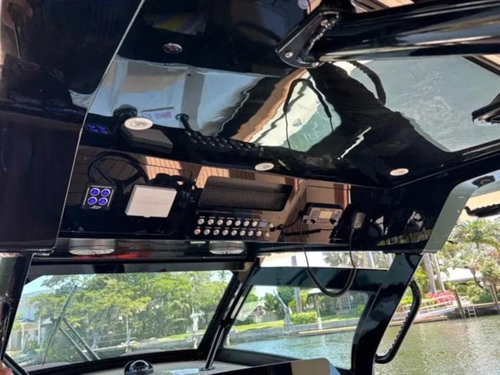  Yacht Photos Pics 2023 Scout 400 LXF boat dashboard with control panel and scenic water view.