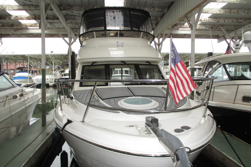 New Lease On Life Yacht Photos Pics 2004 Meridian 340 yacht docked, displaying an American flag, under a covered marina.