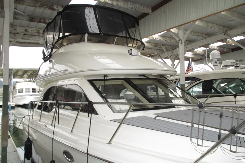 New Lease On Life Yacht Photos Pics 2004 Meridian 340 yacht docked in a covered marina, showcasing sleek design and modern features.