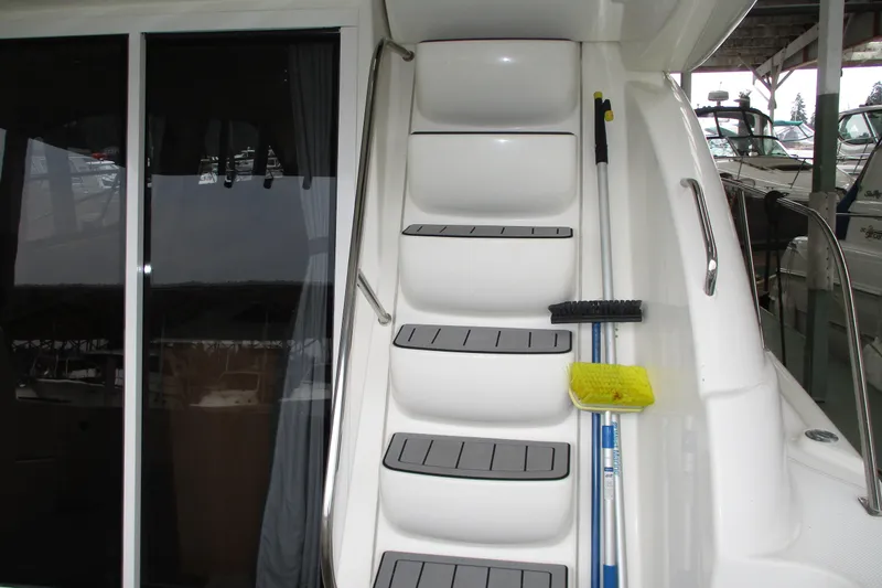 New Lease On Life Yacht Photos Pics Staircase on a 2004 Meridian 340 yacht with cleaning tools attached.