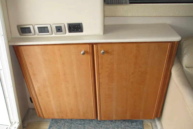 New Lease On Life Yacht Photos Pics Wooden cabinet with countertop and electrical outlets in a 2004 Meridian 340 boat interior.