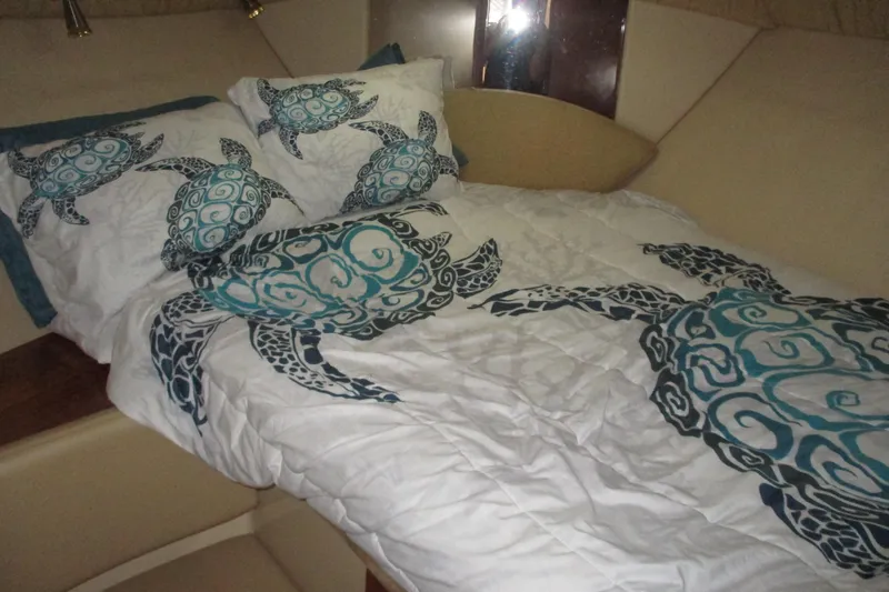 New Lease On Life Yacht Photos Pics Cozy 2004 Meridian 340 cabin with turtle-themed bedding and soft lighting.