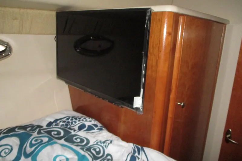 New Lease On Life Yacht Photos Pics Flat-screen TV in 2004 Meridian 340 yacht cabin with wooden cabinetry.