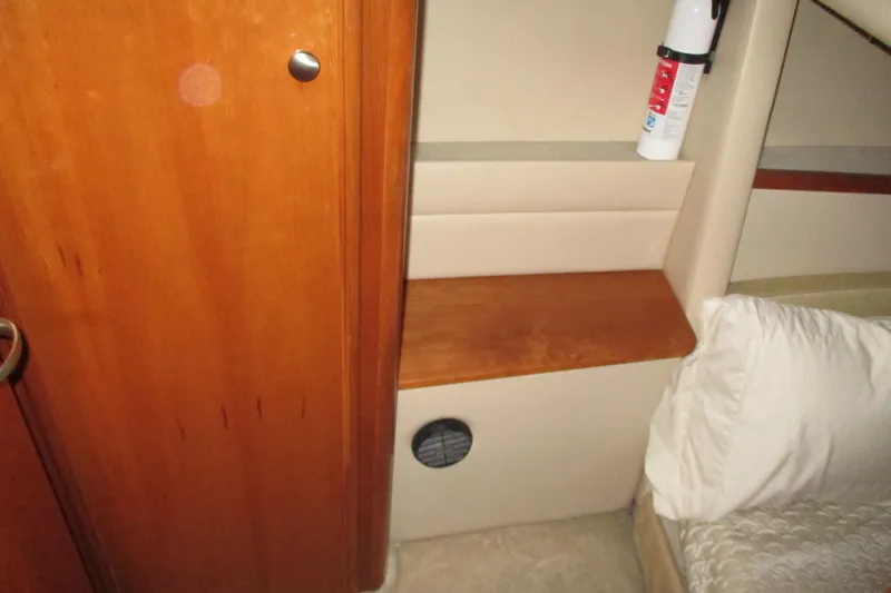 New Lease On Life Yacht Photos Pics Interior of a 2004 Meridian 340 yacht cabin with wooden paneling and a fire extinguisher.
