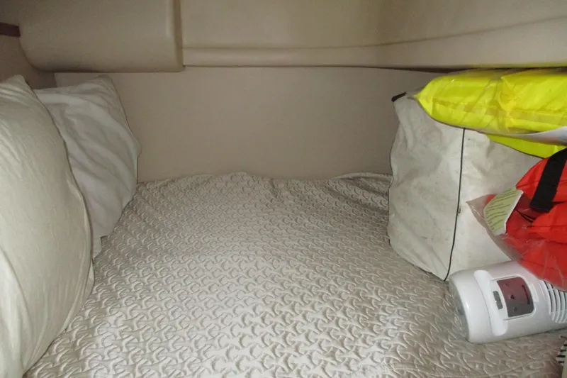 New Lease On Life Yacht Photos Pics Cozy cabin bed in 2004 Meridian 340 yacht with pillows and storage items.