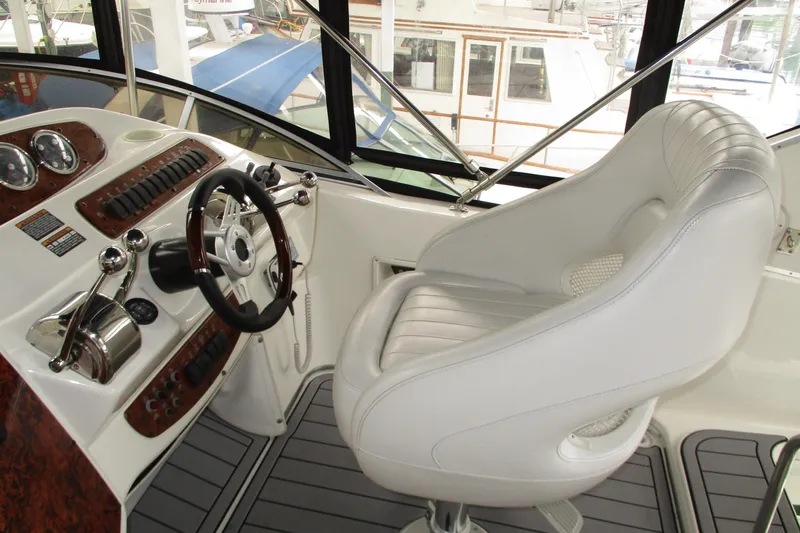 New Lease On Life Yacht Photos Pics 2004 Meridian 340 yacht helm with white captain's chair and control panel.