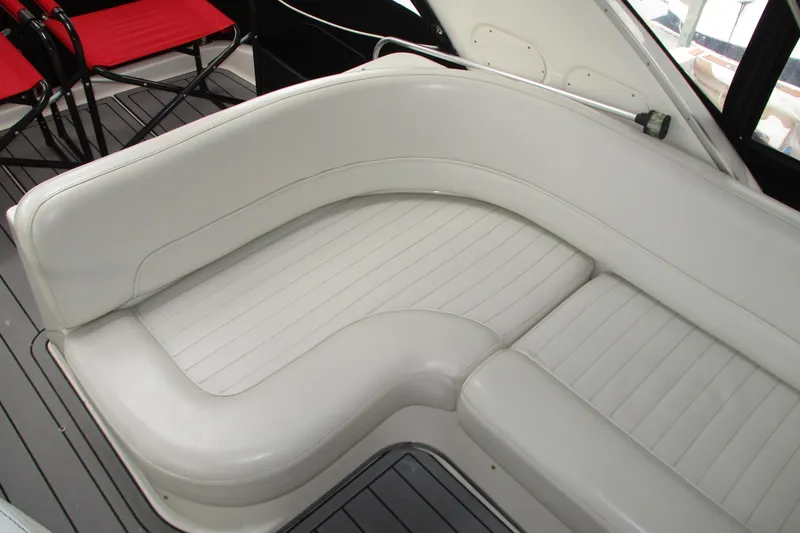 New Lease On Life Yacht Photos Pics White leather seating on a 2004 Meridian 340 boat, with red chairs in the background.