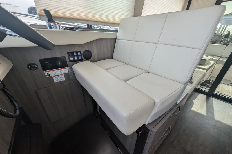  Yacht Photos Pics 2020 Regal 38 Grande Coupe interior helm seat with modern design and controls.