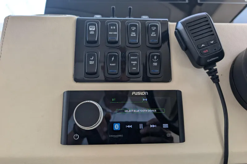  Yacht Photos Pics Control panel of 2020 Regal 38 Grande Coupe with Fusion audio system and Garmin microphone.