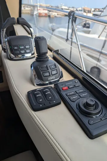  Yacht Photos Pics Control panel of 2020 Regal 38 Grande Coupe yacht with joystick and buttons.