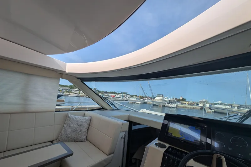  Yacht Photos Pics Interior view of 2020 Regal 38 Grande Coupe yacht with marina backdrop.