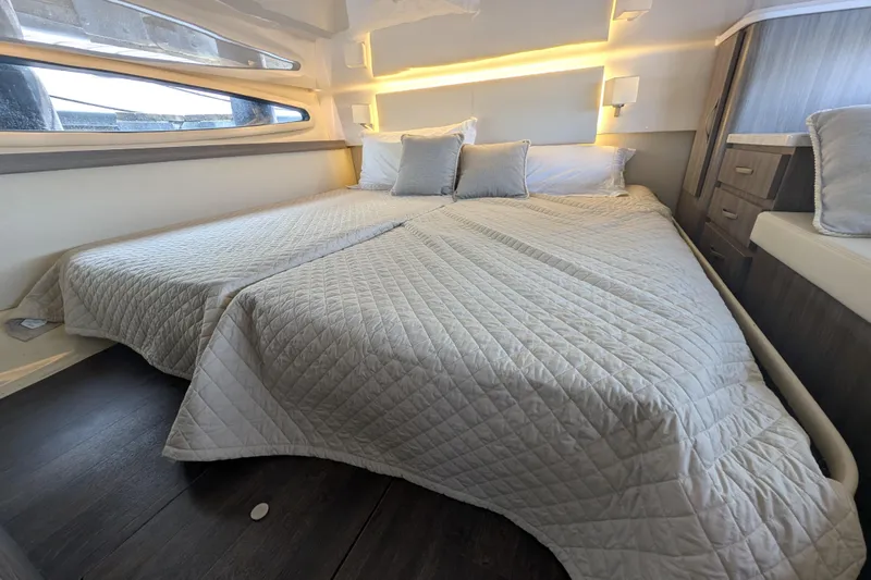  Yacht Photos Pics Luxurious bedroom interior of 2020 Regal 38 Grande Coupe yacht with modern bedding.