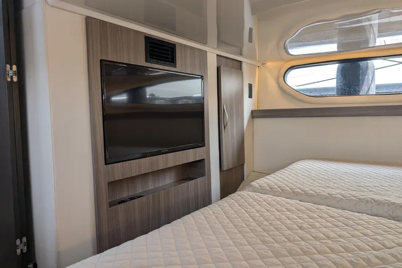  Yacht Photos Pics Interior of 2020 Regal 38 Grande Coupe with twin beds and wall-mounted TV.