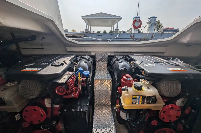  Yacht Photos Pics 2020 Regal 38 Grande Coupe engine compartment with dual engines and metallic walkway.