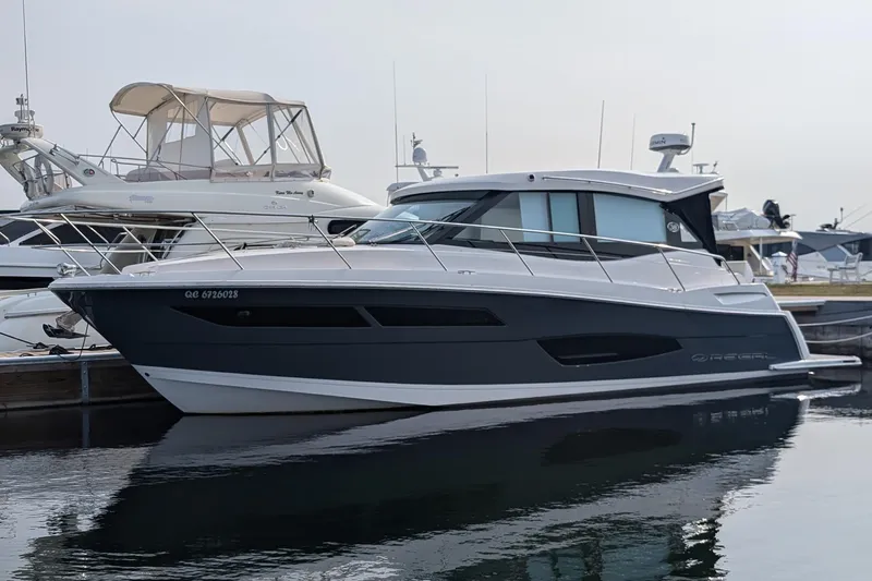  Yacht Photos Pics 2020 Regal 38 Grande Coupe yacht docked at marina, sleek design, calm water reflection.