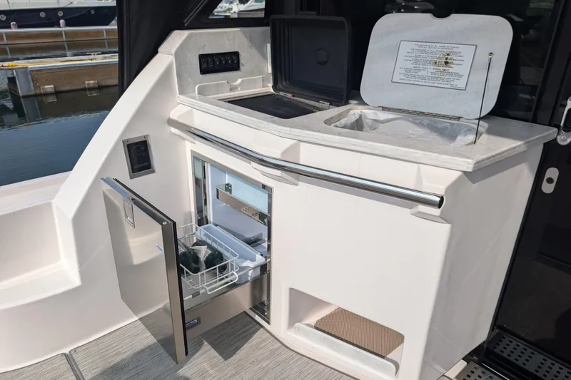  Yacht Photos Pics 2020 Regal 38 Grande Coupe yacht kitchenette with open fridge and storage compartments.