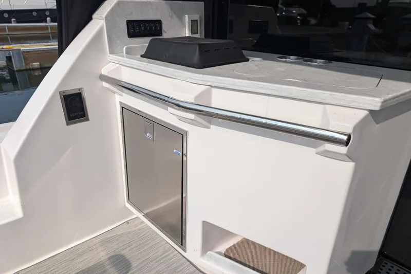  Yacht Photos Pics 2020 Regal 38 Grande Coupe yacht interior with sleek kitchenette and stainless steel accents.