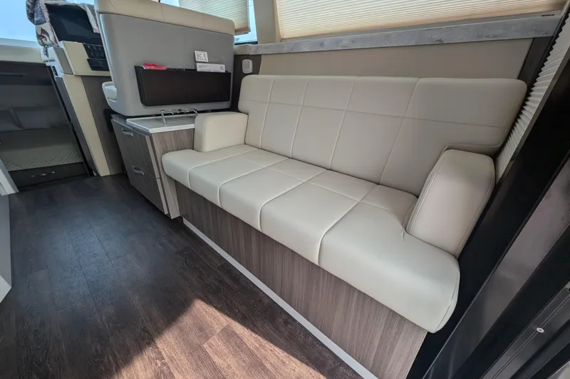  Yacht Photos Pics Interior of 2020 Regal 38 Grande Coupe with beige leather seating and wood flooring.
