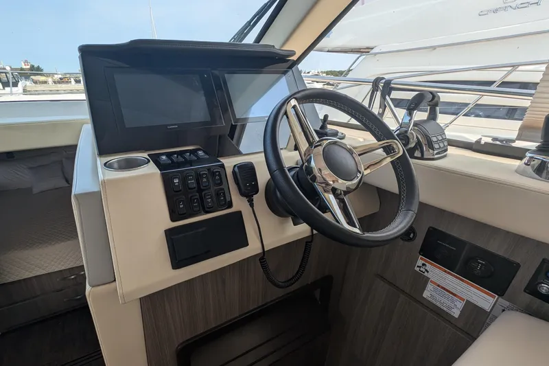 Yacht Photos Pics Helm of 2020 Regal 38 Grande Coupe with steering wheel and control panel.