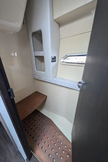 Yacht Photos Pics 2020 Regal 38 Grande Coupe interior cabin with wooden bench and window.