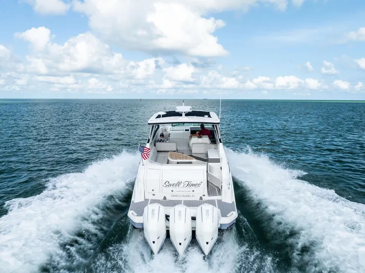 Swelltimes IV Yacht Photos Pics 2022 Sea Ray Sundancer 320 OB cruising on open water under a clear sky.