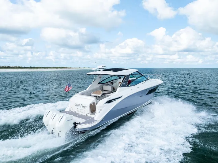 Swelltimes IV Yacht Photos Pics 2022 Sea Ray Sundancer 320 OB cruising on open water under a partly cloudy sky.