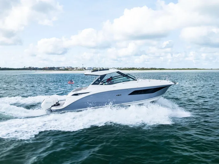 Swelltimes IV Yacht Photos Pics 2022 Sea Ray Sundancer 320 OB cruising on open water under a partly cloudy sky.