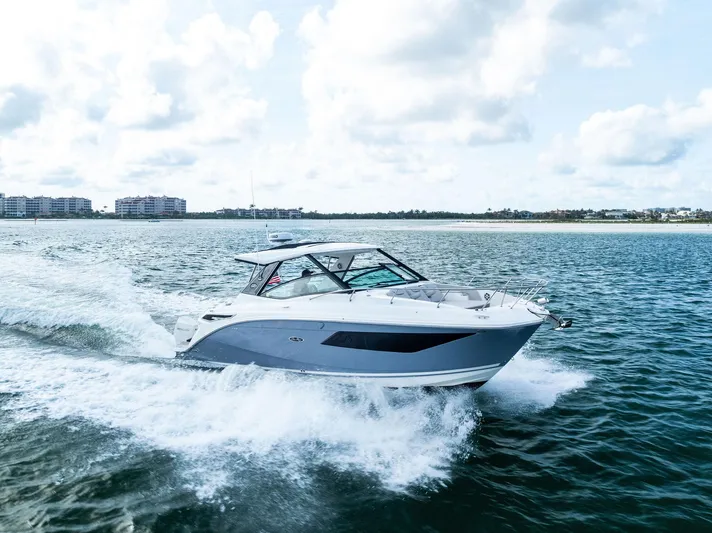 Swelltimes IV Yacht Photos Pics 2022 Sea Ray Sundancer 320 OB cruising on open water under a cloudy sky.