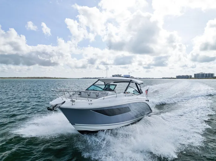 Swelltimes IV Yacht Photos Pics 2022 Sea Ray Sundancer 320 OB cruising on open water under a cloudy sky.