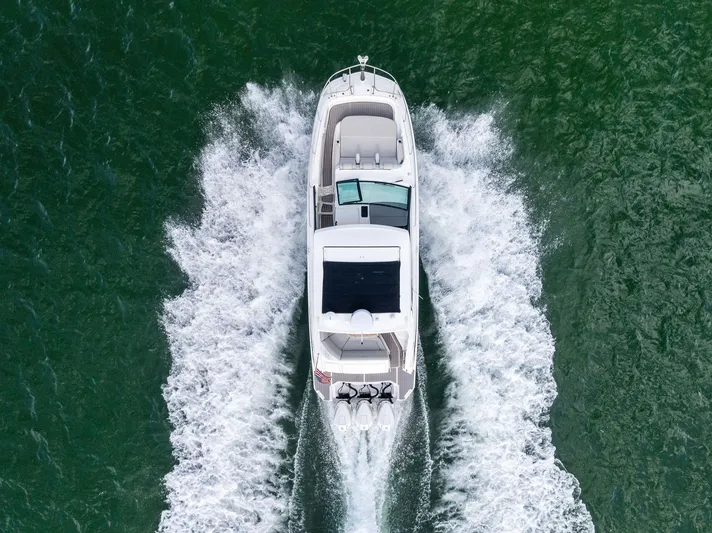 Swelltimes IV Yacht Photos Pics 2022 Sea Ray Sundancer 320 OB cruising on open water, aerial view.