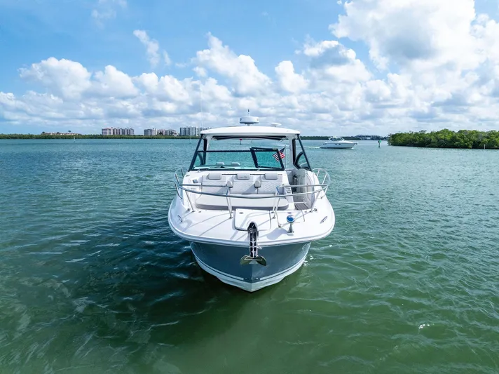 Swelltimes IV Yacht Photos Pics 2022 Sea Ray Sundancer 320 OB yacht on calm water under a partly cloudy sky.